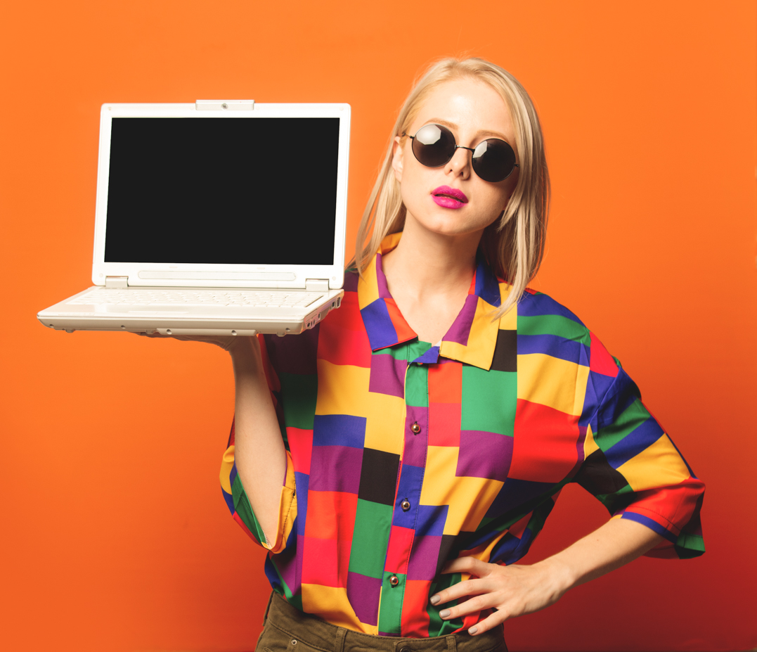 Style blonde in 90s clothes with notebook computer