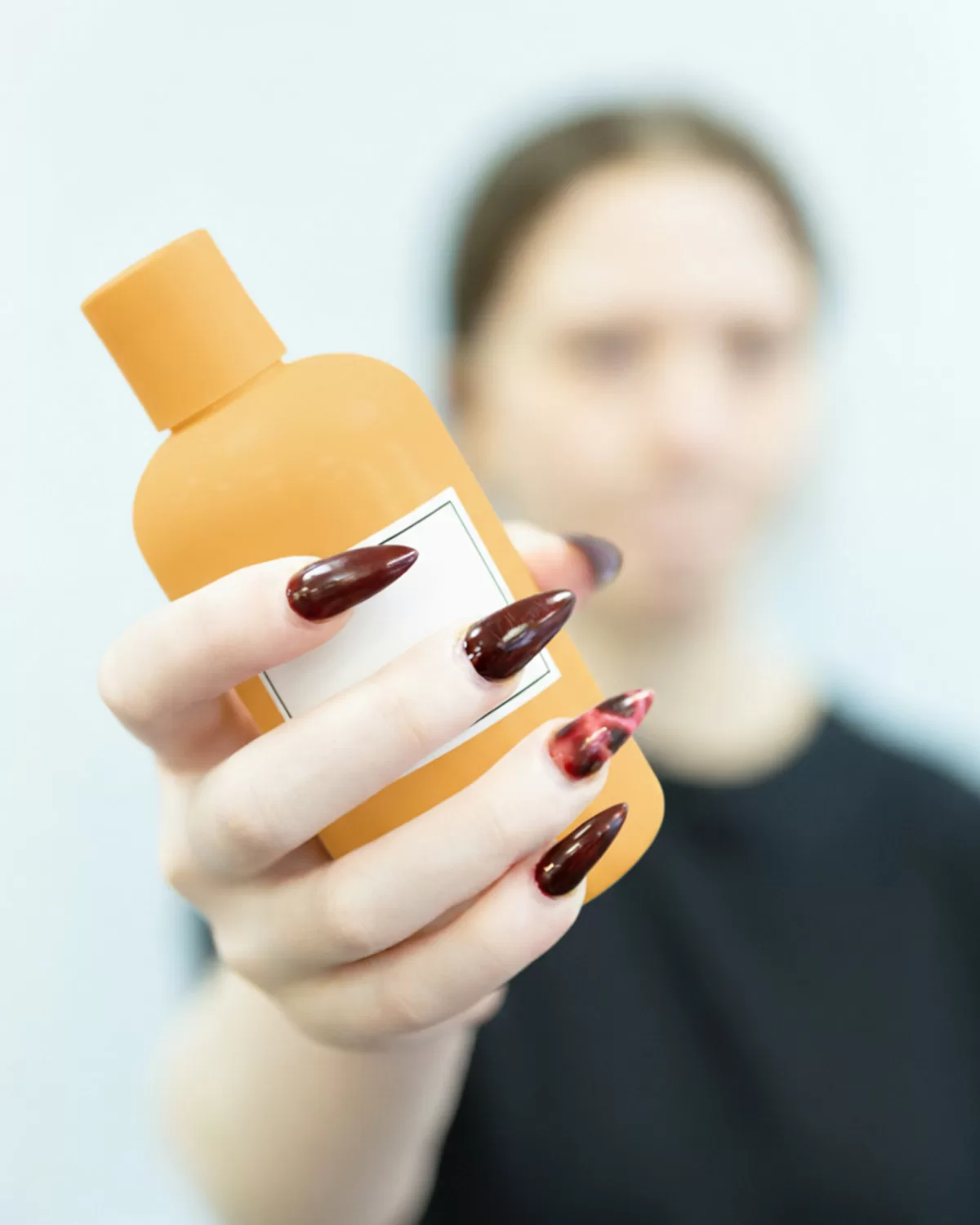 A person holding a bottle