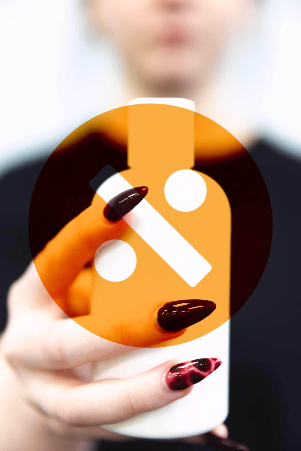 Hannah holding a bottle with the APL logo overlay